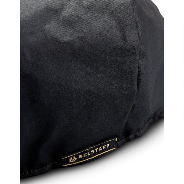 A black Belstaff Hislop Wax Cotton Cap with a gold logo on it.