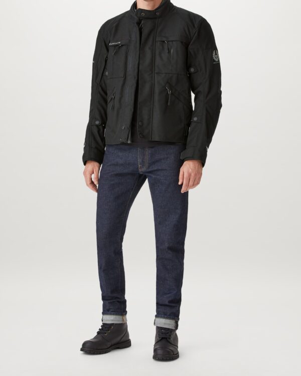 A man wearing a Belstaff Highway Jacket and jeans.